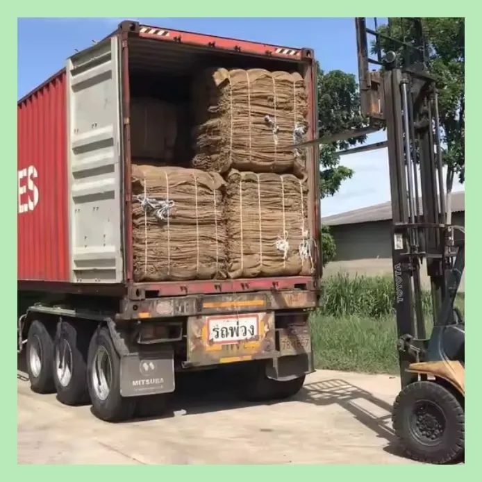 Forklift loading bales of jute sacks into a shipping container for export from Bangladesh